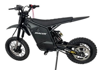 A black Kialuk Bolt 10+ electric dirt bike with knobby tires, a high seat, and a kickstand, shown from a side profile on a white background.